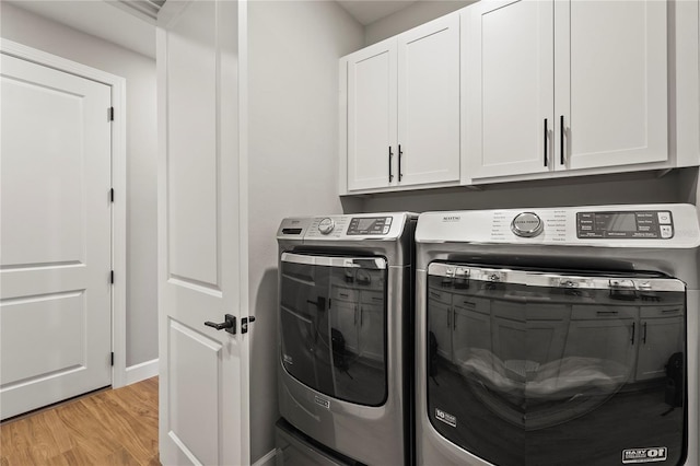 16226 Hidden Oak Loop, Bradenton, FL 34211 - laundry area featuring cabinet space, independent washer and dryer, light wood finished floors, and baseboards