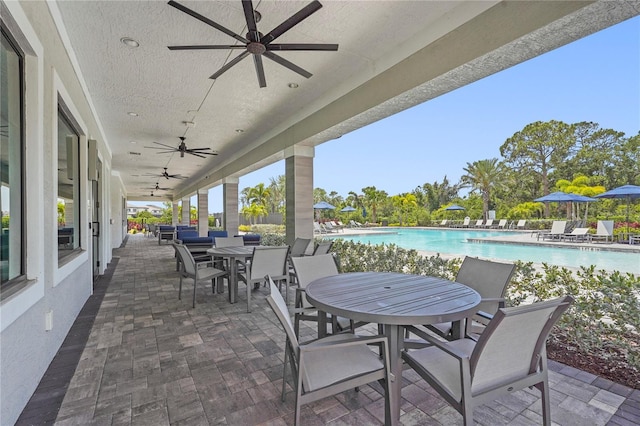 16226 Hidden Oak Loop, Bradenton, FL 34211 - view of patio / terrace featuring outdoor dining area, ceiling fan, and a community pool