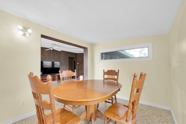 6628 Auburn Ave, Bradenton, FL 34207 - dining room with dark speckled floor, baseboards, and a ceiling fan