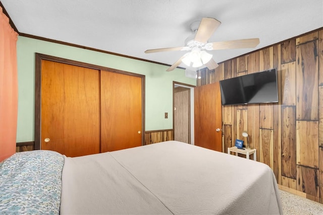 6628 Auburn Ave, Bradenton, FL 34207 - bedroom with wooden walls, a closet, a ceiling fan, and ornamental molding