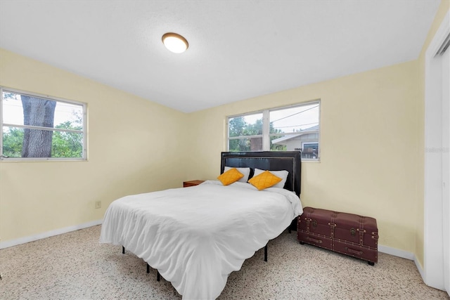 6628 Auburn Ave, Bradenton, FL 34207 - bedroom with multiple windows, baseboards, and speckle patterned floor