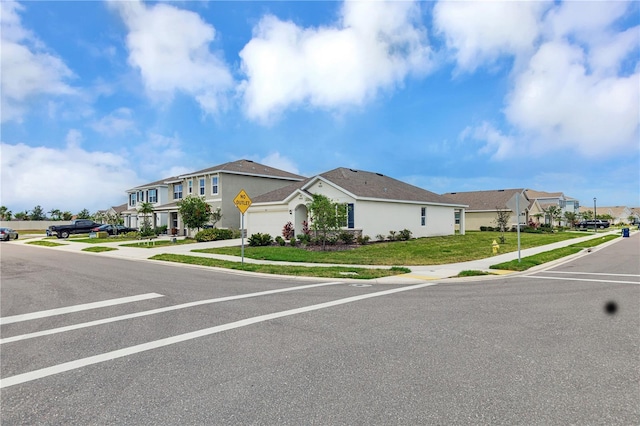 view of front of house featuring a residential view, stucco siding, driveway, and an attached garage