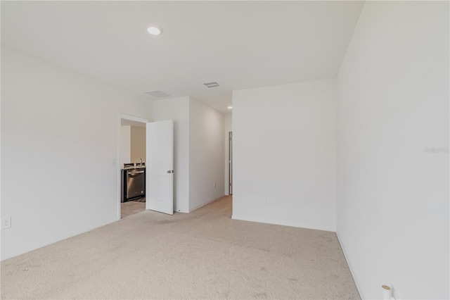 empty room featuring light colored carpet and recessed lighting