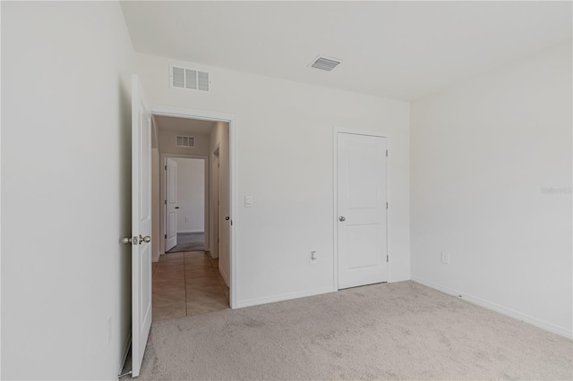 unfurnished bedroom with carpet floors and baseboards