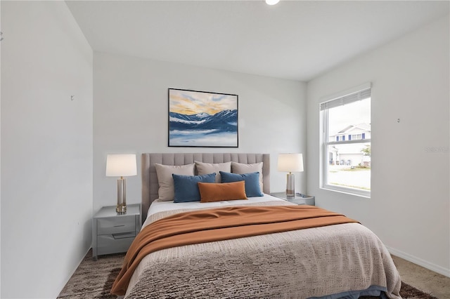 carpeted bedroom featuring baseboards