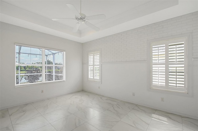 5320 Tide Point Way, Bradenton, FL 34208 - empty room featuring a ceiling fan and a raised ceiling