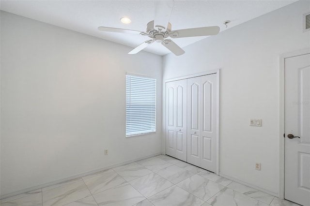 5320 Tide Point Way, Bradenton, FL 34208 - unfurnished bedroom with a closet, light marble finish flooring, baseboards, and ceiling fan