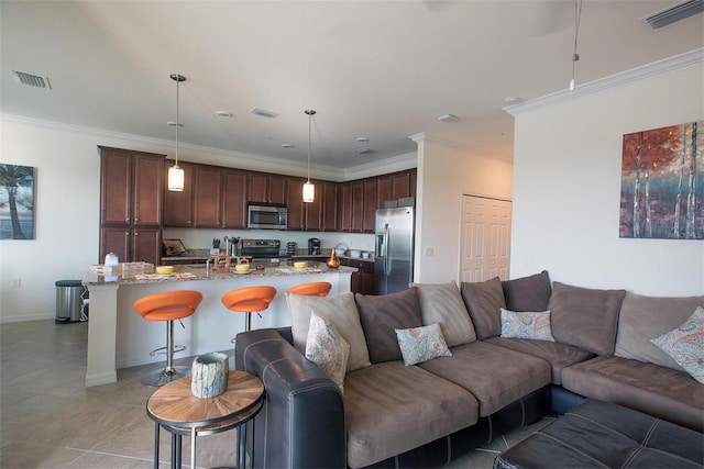 living area featuring ornamental molding, light tile patterned floors, and baseboards