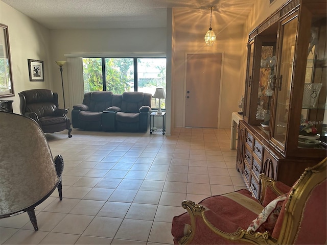 2181 Pine Gardens Trl, Sarasota, FL 34231 - living room featuring healthy amount of natural light, light tile patterned floors, and a textured ceiling