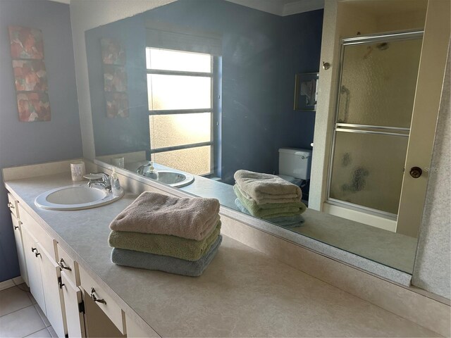 2181 Pine Gardens Trl, Sarasota, FL 34231 - full bathroom featuring an enclosed shower, toilet, double vanity, and tile patterned floors
