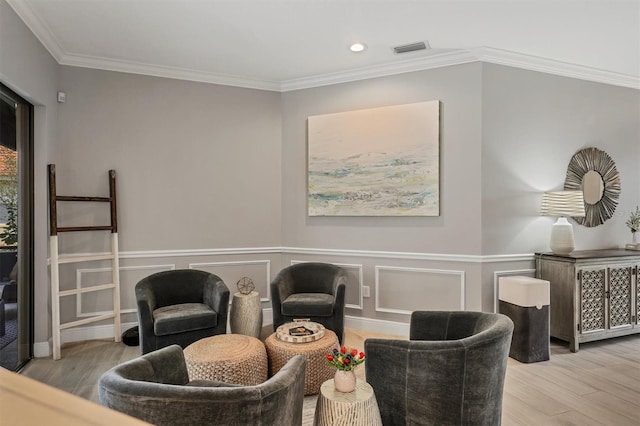 6470 Indigo Bunting Pl, Lakewood Ranch, FL 34202 - living area with wood finished floors, recessed lighting, and ornamental molding