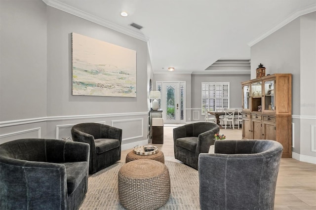 6470 Indigo Bunting Pl, Lakewood Ranch, FL 34202 - living area featuring ornamental molding, a decorative wall, light wood-style flooring, recessed lighting, and a wainscoted wall