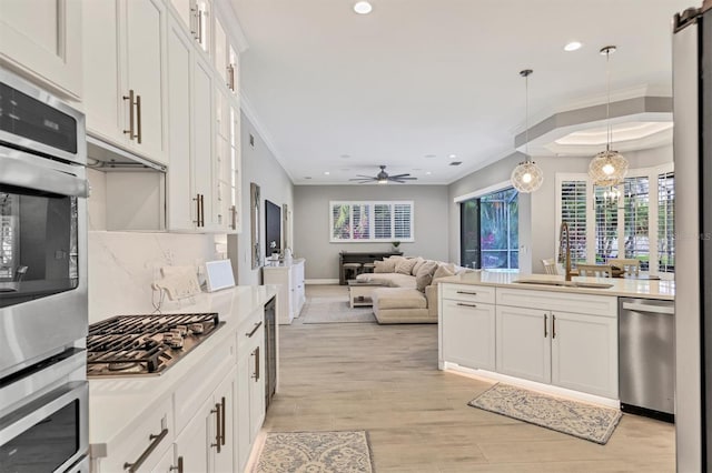 6470 Indigo Bunting Pl, Lakewood Ranch, FL 34202 - kitchen with appliances with stainless steel finishes, recessed lighting, backsplash, decorative light fixtures, and glass insert cabinets