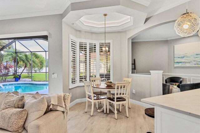 6470 Indigo Bunting Pl, Lakewood Ranch, FL 34202 - dining area with light wood finished floors, crown molding, and arched walkways