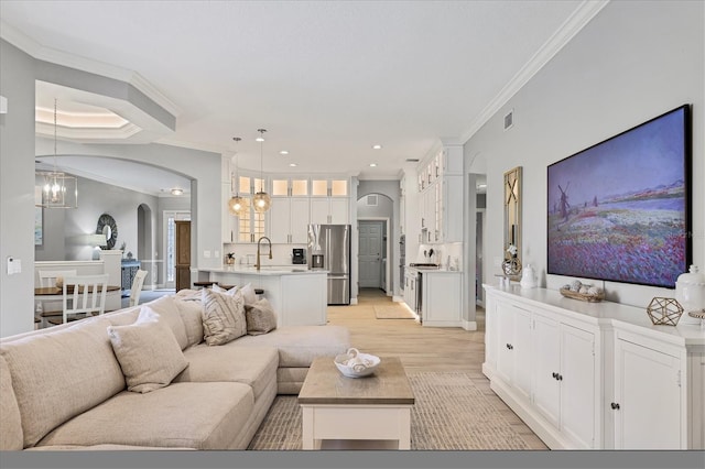 6470 Indigo Bunting Pl, Lakewood Ranch, FL 34202 - living area featuring arched walkways, a chandelier, ornamental molding, light wood-style floors, and recessed lighting
