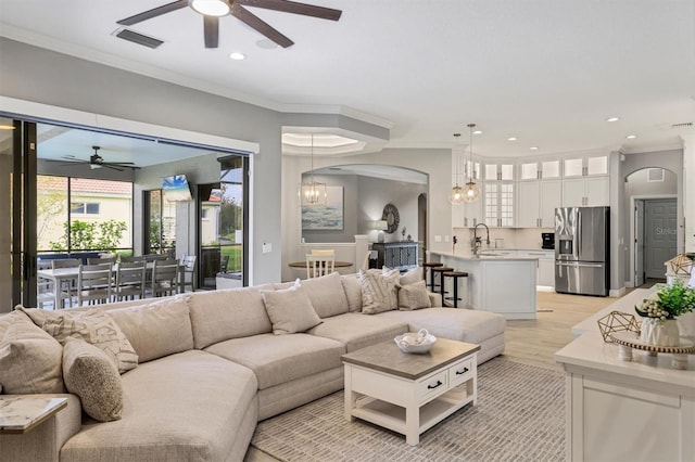 6470 Indigo Bunting Pl, Lakewood Ranch, FL 34202 - living area with ceiling fan, arched walkways, a chandelier, ornamental molding, and recessed lighting