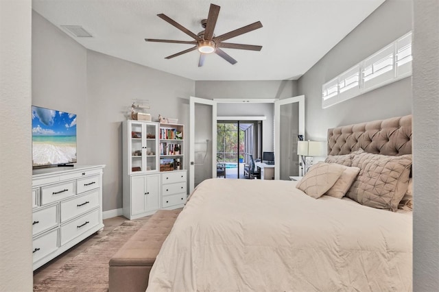 6470 Indigo Bunting Pl, Lakewood Ranch, FL 34202 - bedroom with access to exterior, a ceiling fan, and light wood-type flooring