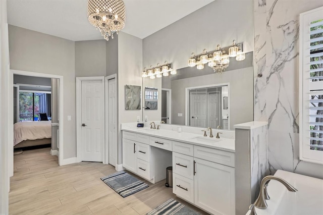 6470 Indigo Bunting Pl, Lakewood Ranch, FL 34202 - full bathroom with a chandelier, double vanity, and wood finished floors