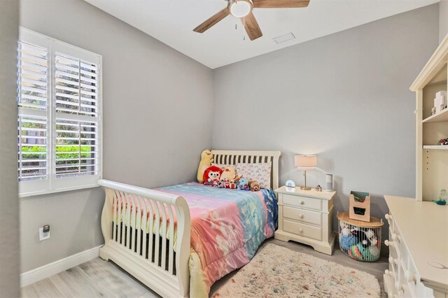 6470 Indigo Bunting Pl, Lakewood Ranch, FL 34202 - bedroom featuring multiple windows, wood finished floors, and ceiling fan