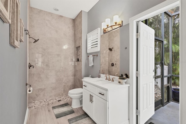 6470 Indigo Bunting Pl, Lakewood Ranch, FL 34202 - bathroom with vanity, a tile shower, and wood finished floors