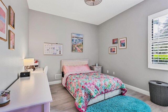 6470 Indigo Bunting Pl, Lakewood Ranch, FL 34202 - bedroom with wood finished floors and baseboards