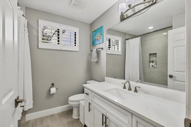 6470 Indigo Bunting Pl, Lakewood Ranch, FL 34202 - bathroom with wood finished floors, vanity, and a shower with shower curtain