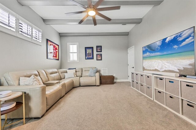 6470 Indigo Bunting Pl, Lakewood Ranch, FL 34202 - carpeted living room with beam ceiling and a ceiling fan