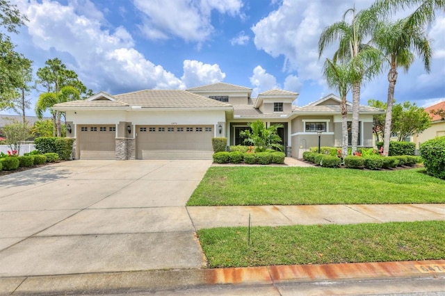 6470 Indigo Bunting Pl, Lakewood Ranch, FL 34202 - prairie-style home with a garage, stucco siding, driveway, a front yard, and a tiled roof