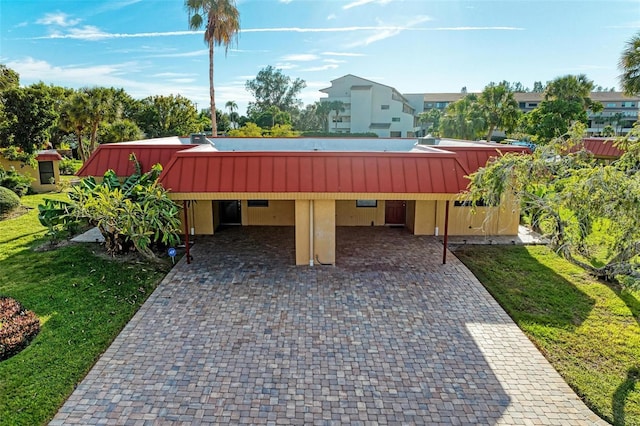 9409 Catalina Dr, Bradenton, FL 34210 - view of home's community featuring driveway, an attached carport, and a yard