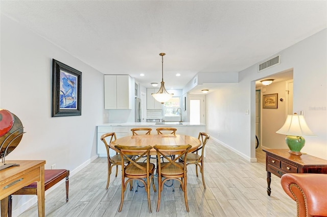 9409 Catalina Dr, Bradenton, FL 34210 - dining area with light wood-type flooring, baseboards, and recessed lighting