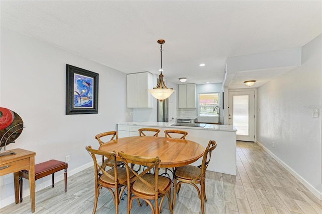 9409 Catalina Dr, Bradenton, FL 34210 - dining room with light wood finished floors, baseboards, and recessed lighting