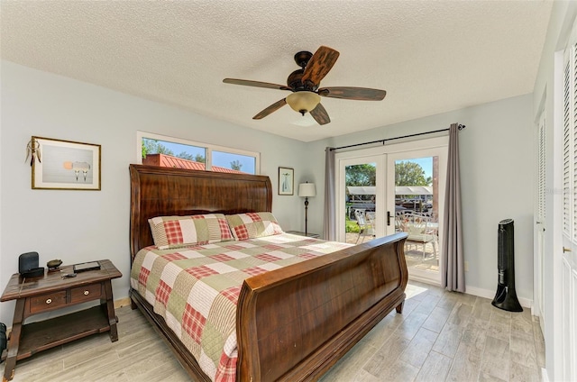9409 Catalina Dr, Bradenton, FL 34210 - bedroom featuring access to outside, light wood-type flooring, french doors, a textured ceiling, and a ceiling fan
