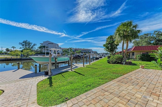 9409 Catalina Dr, Bradenton, FL 34210 - dock area featuring boat lift, a water view, and a lawn