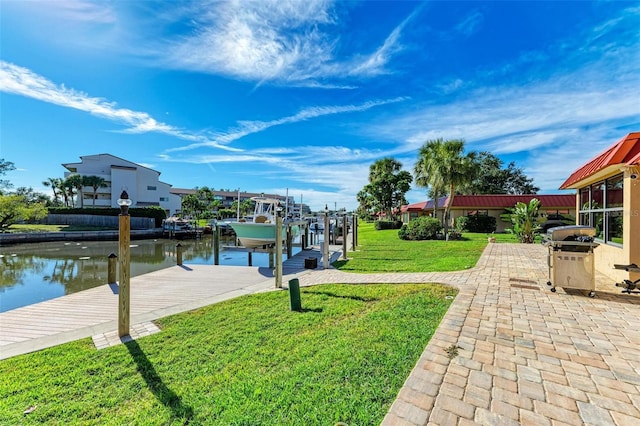 9409 Catalina Dr, Bradenton, FL 34210 - dock area with boat lift, a water view, a lawn, and a patio area
