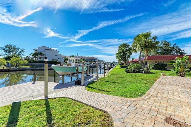 9409 Catalina Dr, Bradenton, FL 34210 - view of community featuring boat lift, a dock, a water view, and a yard