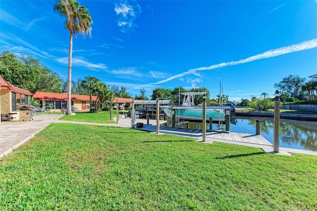 9409 Catalina Dr, Bradenton, FL 34210 - dock area with boat lift, a water view, and a lawn