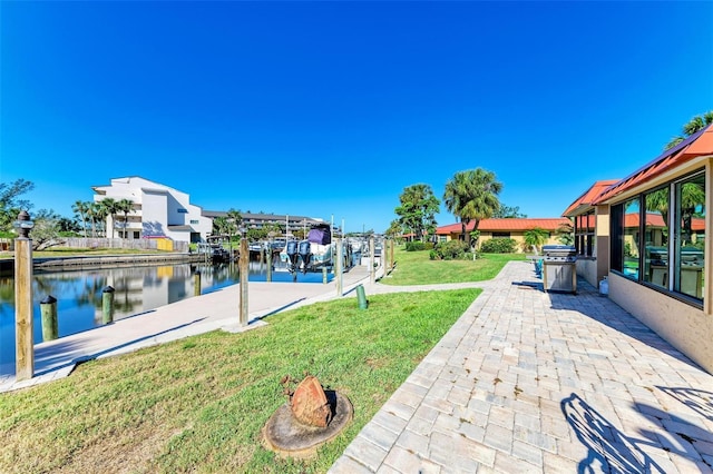 9409 Catalina Dr, Bradenton, FL 34210 - view of green lawn featuring a water view, a dock, a patio, and boat lift