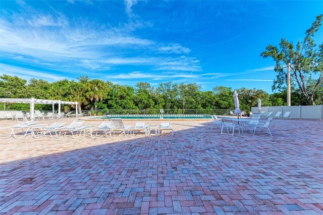 9409 Catalina Dr, Bradenton, FL 34210 - community pool featuring a pergola, fence, a patio, and view of scattered trees