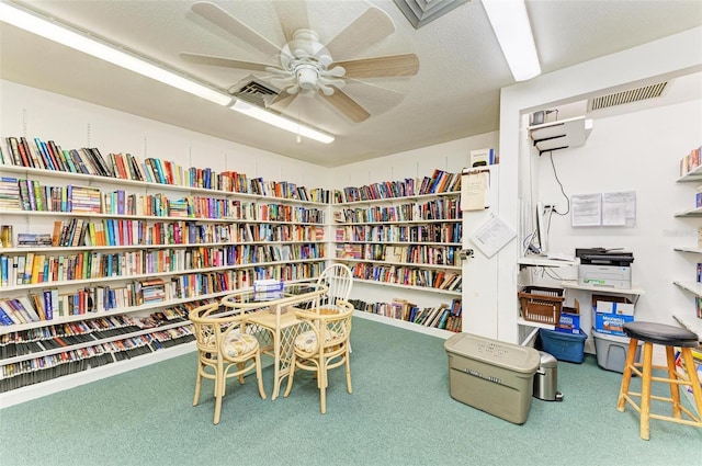 9409 Catalina Dr, Bradenton, FL 34210 - living area featuring wall of books, carpet floors, and ceiling fan