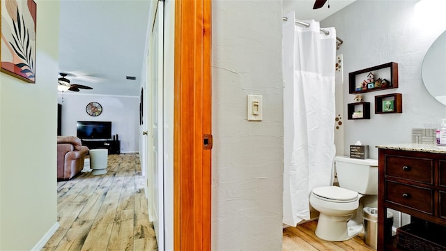 1010 68th St NW, Bradenton, FL 34209 - full bathroom with ceiling fan, wood finished floors, toilet, vanity, and a shower with curtain