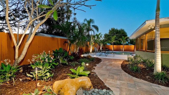 1010 68th St NW, Bradenton, FL 34209 - fenced backyard with a patio area and a sunroom
