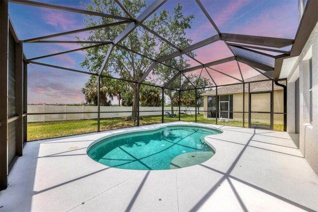 pool at dusk with a patio, fence, and glass enclosure