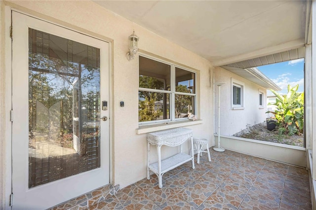 property entrance with stucco siding
