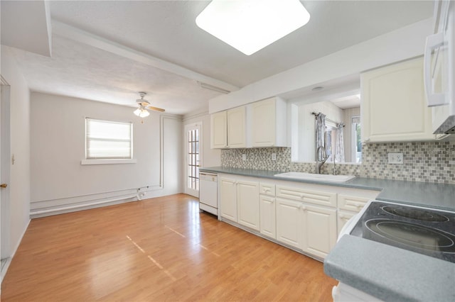 kitchen featuring white cabinets, white appliances, tasteful backsplash, and a sink