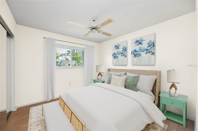 bedroom featuring wood finished floors, baseboards, a closet, and a ceiling fan