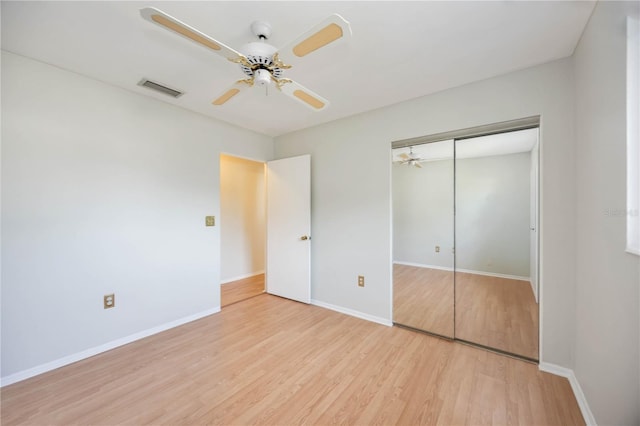 unfurnished bedroom with a ceiling fan, a closet, light wood-type flooring, visible vents, and baseboards