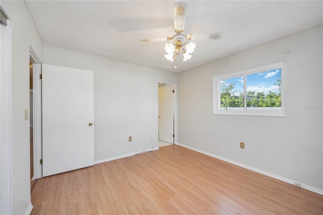 unfurnished bedroom with light wood-style flooring, baseboards, and a ceiling fan