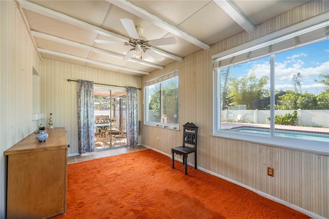 living area with baseboards and a ceiling fan