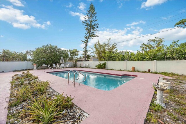 view of swimming pool featuring a patio area, a fenced in pool, and a fenced backyard
