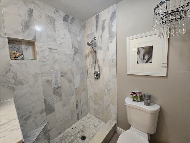 bathroom with tiled shower and toilet